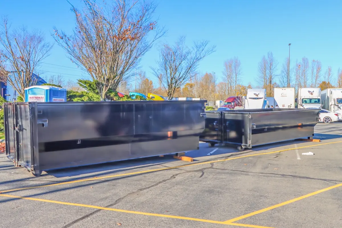 Professional dumpster rental service with roll-off container on residential driveway in Stoneham